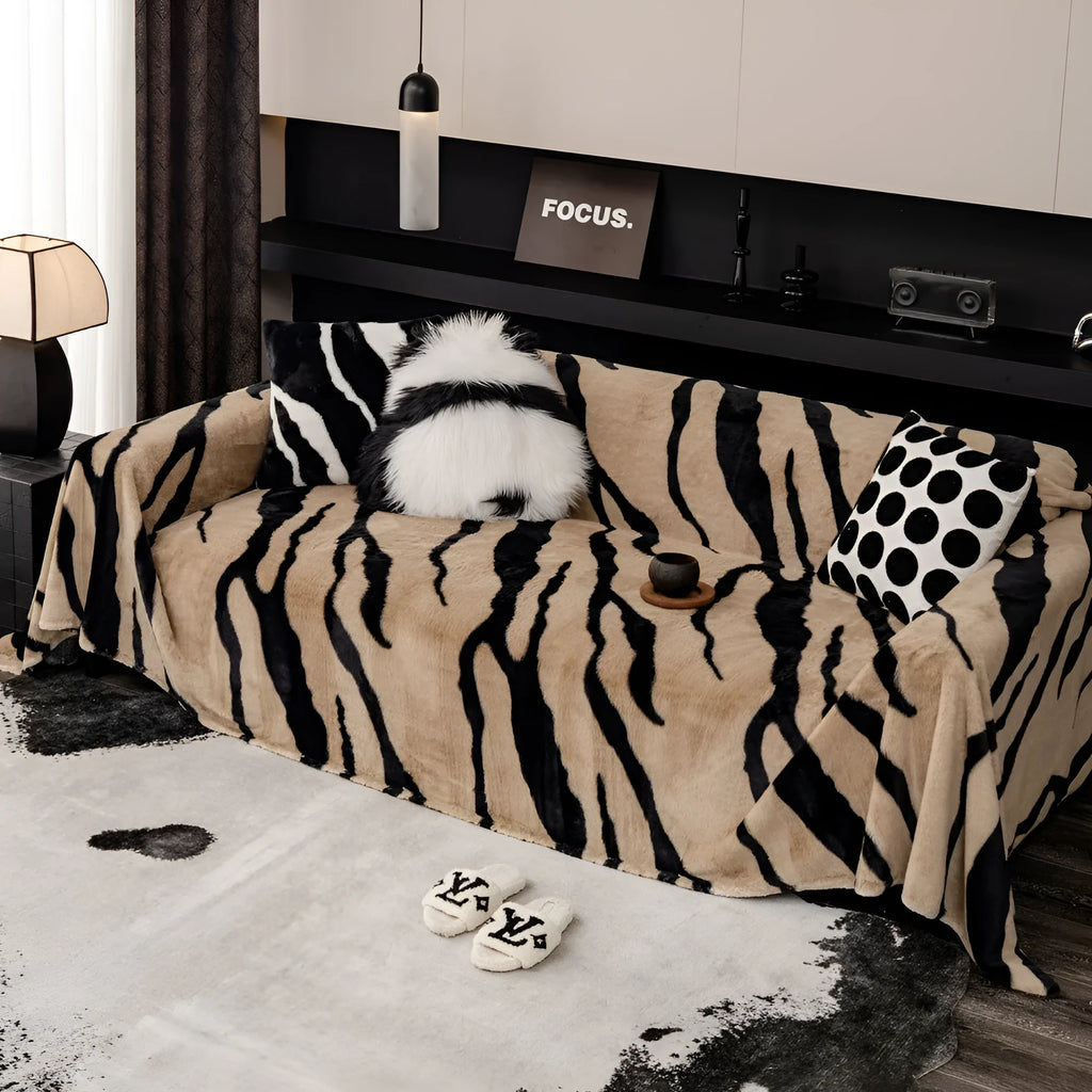 Zebra pattern flannel sofa slipcover in caramel colour, shown draped over a sofa.