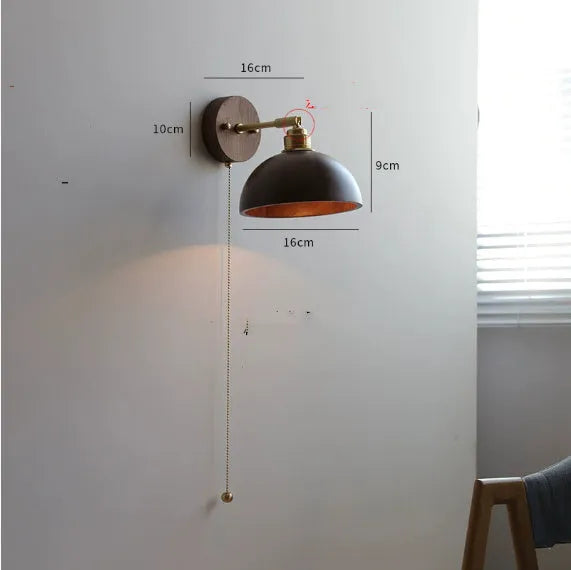 Nordic-style wooden wall lamp mounted beside a bed, shown in walnut brown and natural wood colour options.