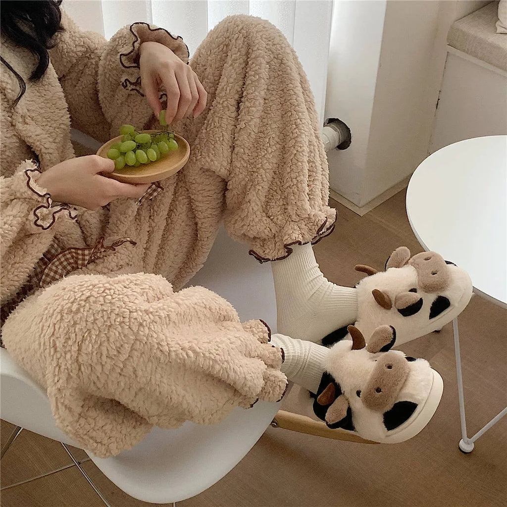 White cow design slippers with plush faux fur upper and textured non-slip sole