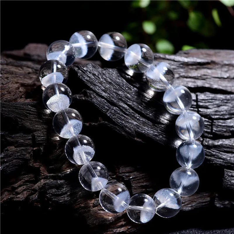 Women's natural white crystal pyramid ghost bracelet with Ruyi charm showing bead texture