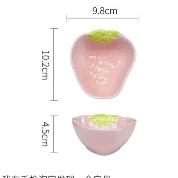Porcelain dinnerware set with strawberry design showing plates, flower bowls, and twist spoon