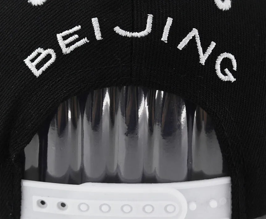 Cotton baseball hat with dome crown and letter embroidery in white or black with adjustable strap