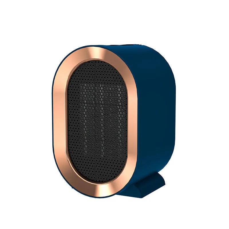 Compact black desktop electric ceramic fan heater with mechanical controls on a wooden desk