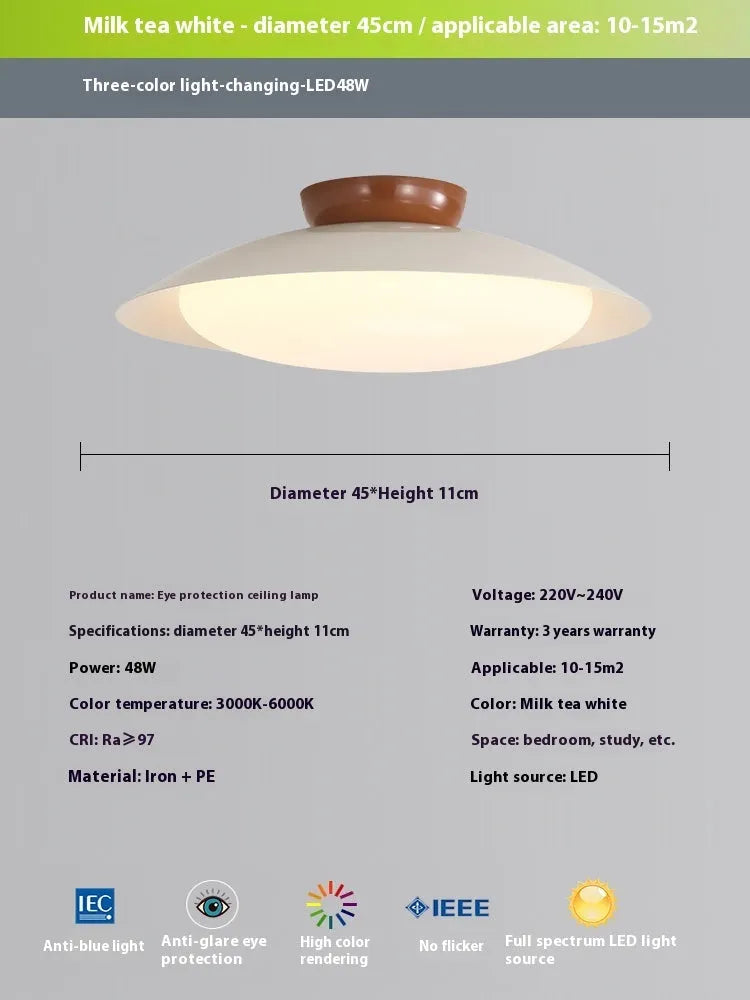 Modern flying saucer shaped ceiling lamp with an iron shade, shown in a cream yellow finish.