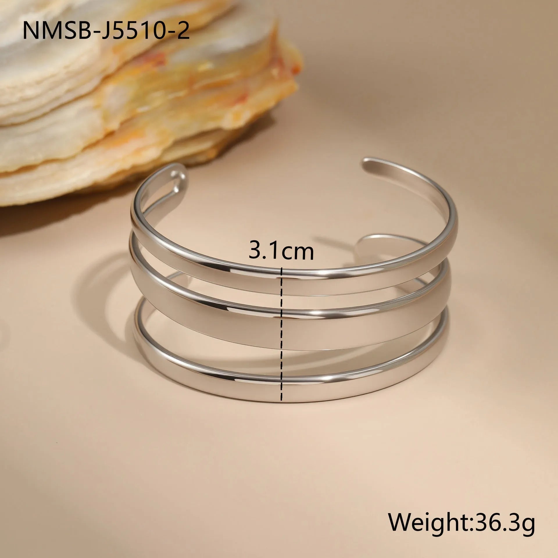 Geometric stainless steel women's bracelet with a simple opening mechanism, shown in gold and steel finish options.