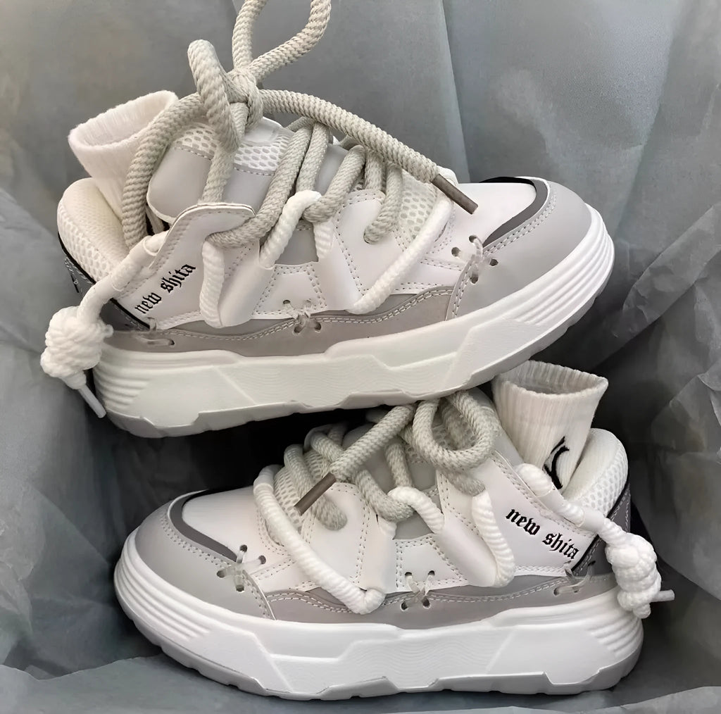 Women's grey retro platform sneakers with thick rubber sole and front lace-up closure
