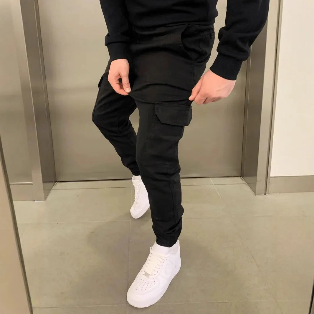 Men's loose-fit polyester casual trousers with elastic waistband and patch pockets in army green colour