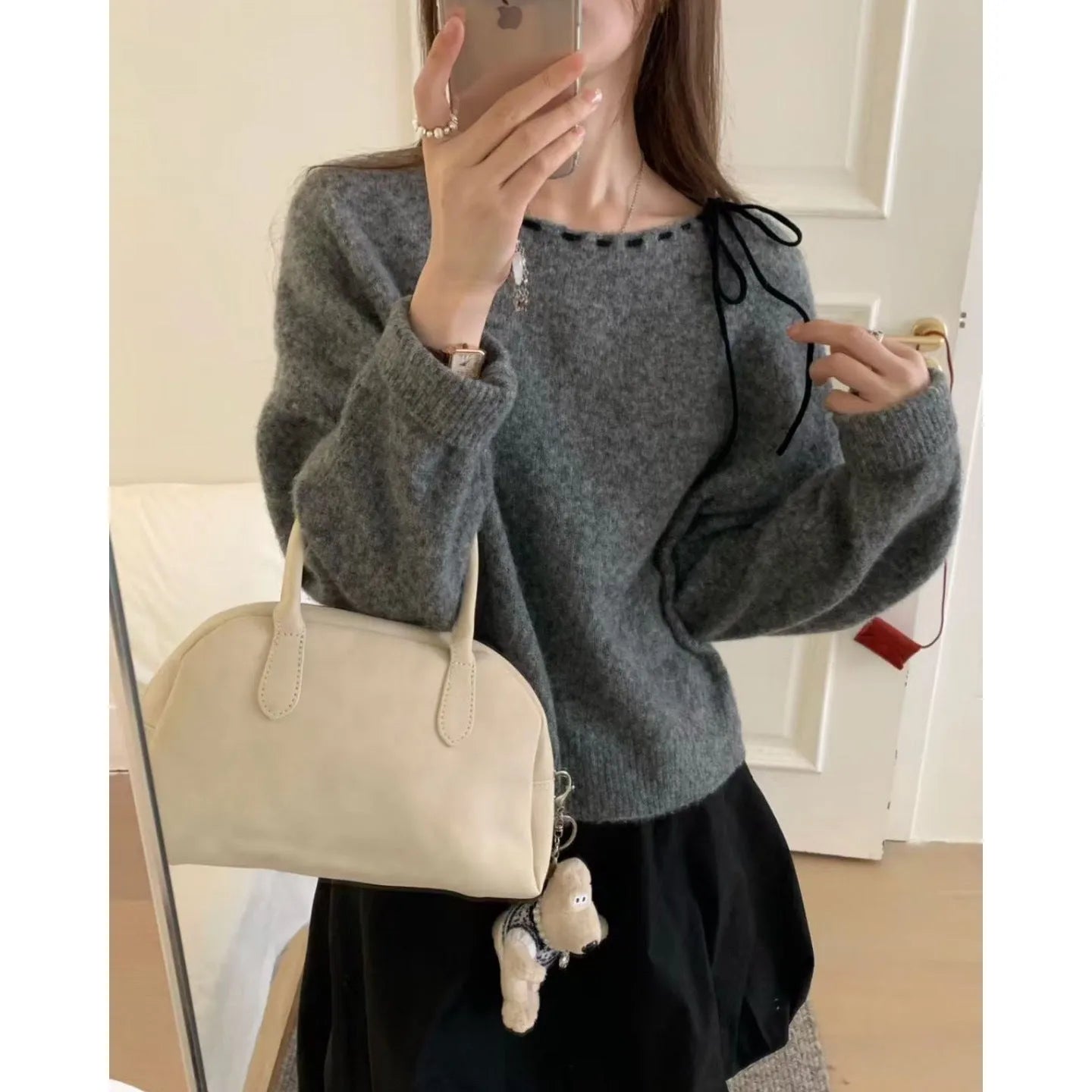 A grey loose-fitting women's knitwear pullover made from regenerated cellulose fibre.