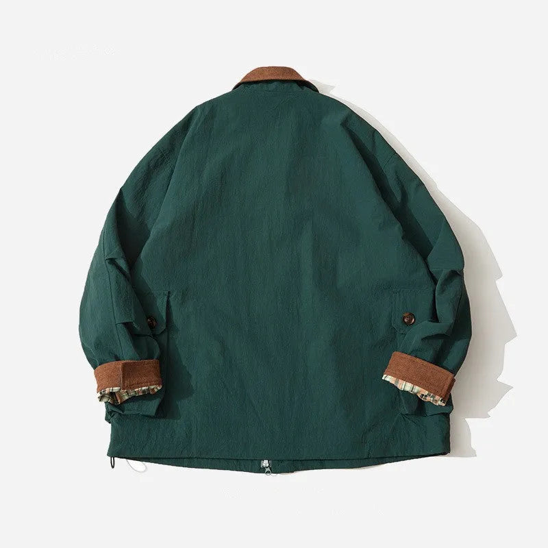 Green unisex casual jacket with contrast colour panels and side seam pockets on a model.