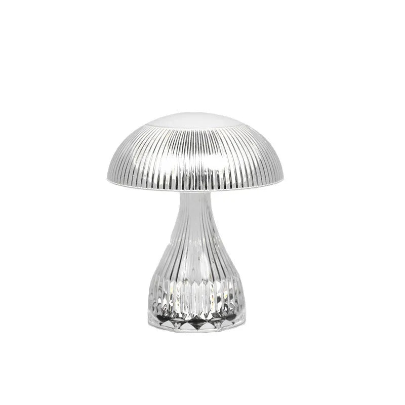 White rechargeable touch control bedside lamp with acrylic shade on a table.