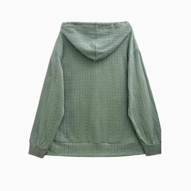 Green women's hooded zipper coat with long sleeves on a hanger