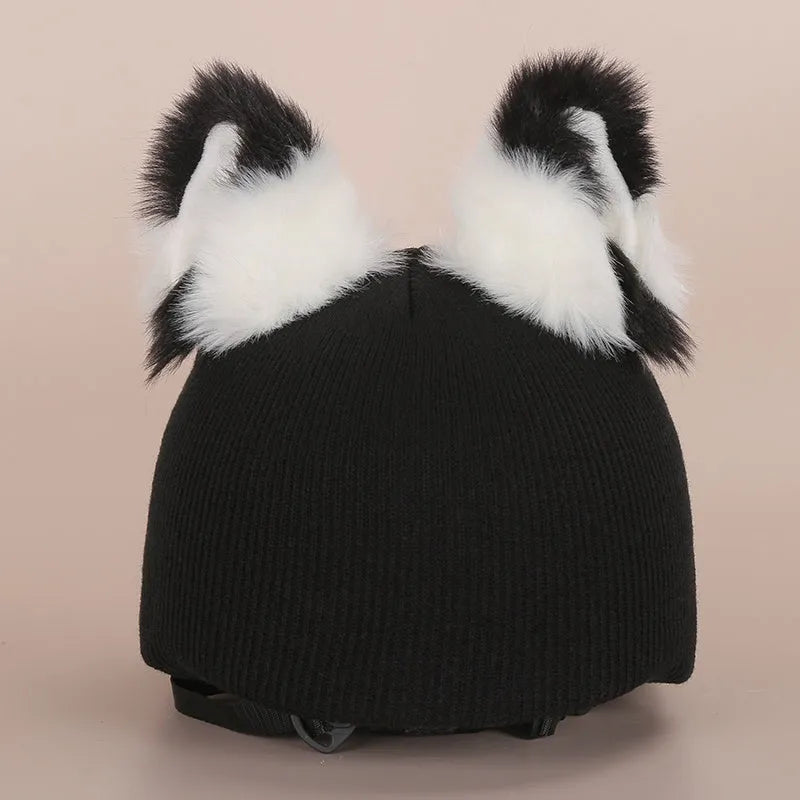 Plush fabric ski helmet decoration with cartoon design on a black ski helmet.