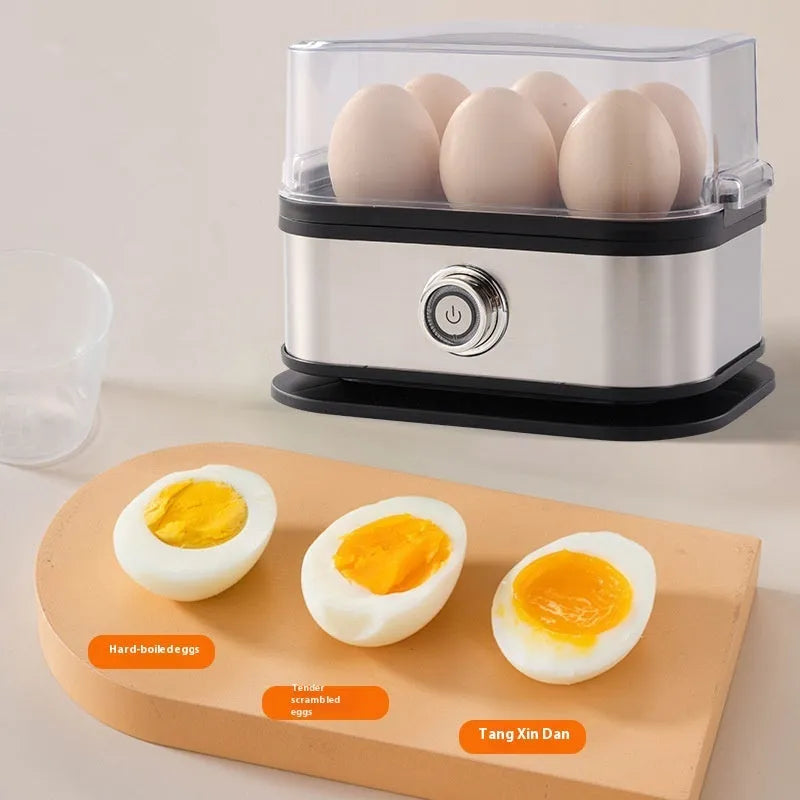 Black portable stainless steel mini egg boiler for travel with multiple power plugs.