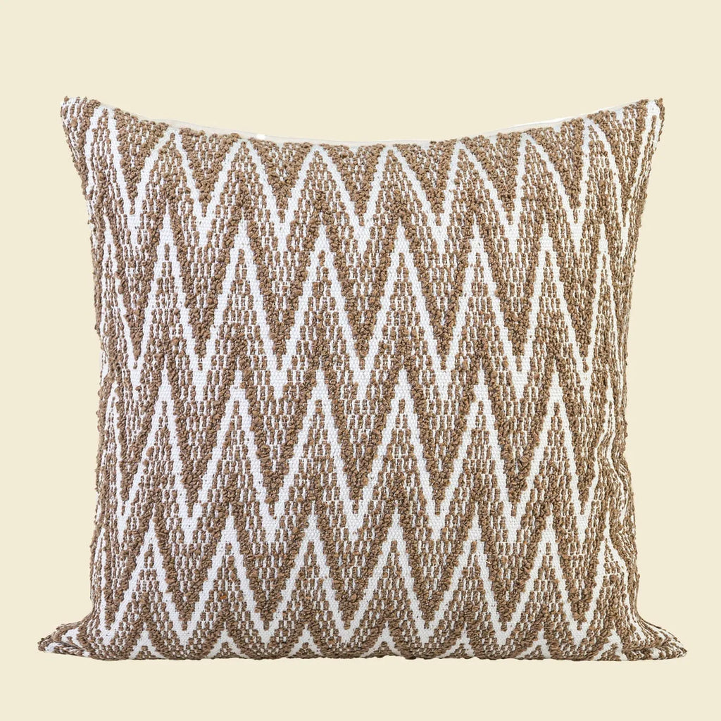 Square Chinese ancient style decorative cushion with a geometric pattern in a brown Maillard colour on a grey sofa.