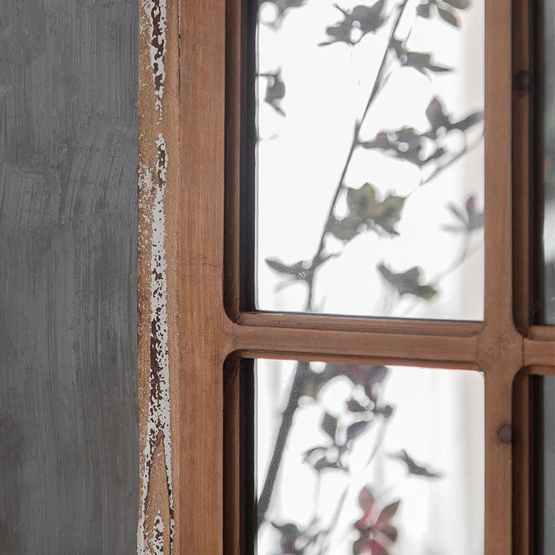Terrace distressed wooden frame fake window wall mirror in log colour hanging on a wall.
