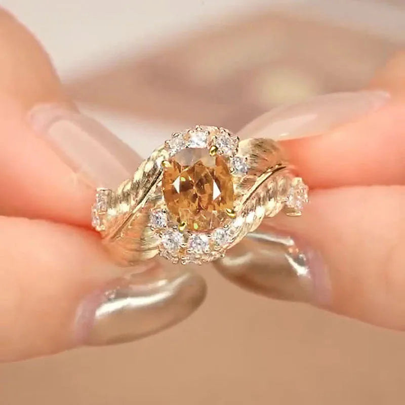 Women's gold geometric feather ring with yellow zircon stones on copper band
