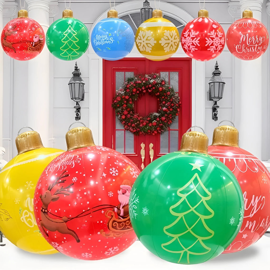 Large red and white inflatable Christmas ball with snowflake design in garden setting