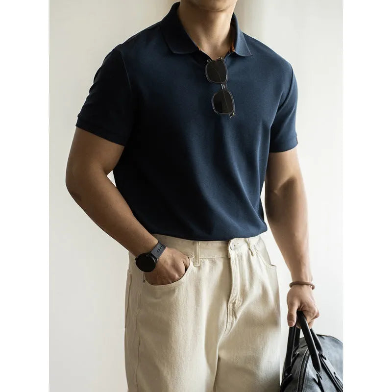 Blue short-sleeved cotton blend polo shirt for men on a hanger, showing regular fit and button placket.