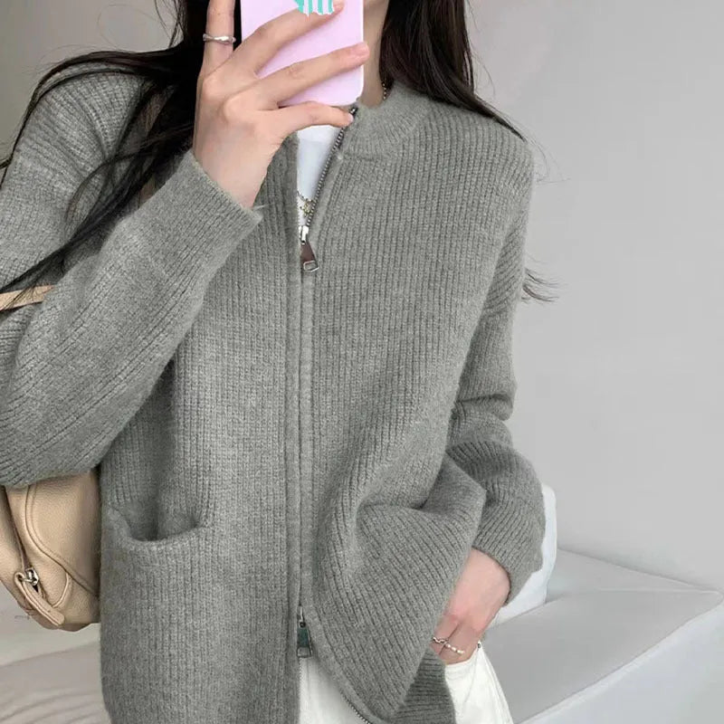 Beige soft viscose knit cardigan with long sleeves shown on a hanger.
