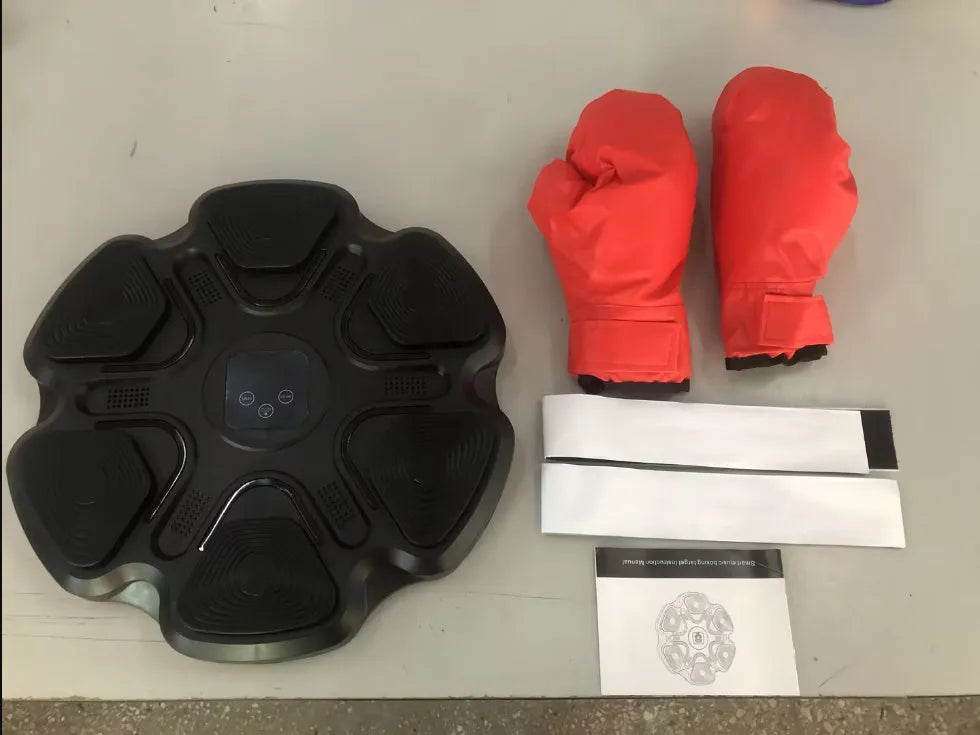 Smart electronic boxing target mounted on a wall, with black and white boxing gloves for reaction training.